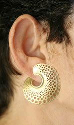 Spiral earrings in 18K gold, shown on ear